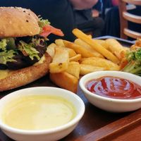 Bhakti burger with chips and salad at Radhey Chai Bar in Fitzroy