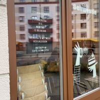 Entrance of cafe with logo and opening times  at Café Schwestis in Sachsen