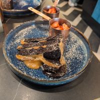 Vegan Salted Caramel Chocolate Fudge Cake, served with strawberries at The Urban Chocolatier Cardiff Bay  in Cardiff