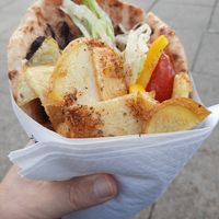 Vegan Greek wrap, generously filled with potatoes and freshly cut salad. at Greekatessen Gyros Brighton Halal in England