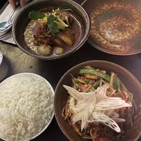 Vegan pork belly in top left corner and som tam (green papaya) salad in bottom right  at Kruk in London