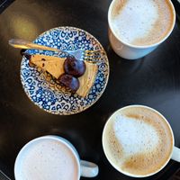 Salted caramel chocolate cake, out lattes and an oat babyccinoo  at Coffeelogy in England