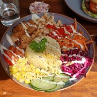 Rainbow salad bowl, burger in the background. So good! at Soul Bowl in London