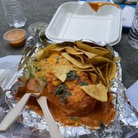 Veggie burrito “wet” style with vegan cheese and both sauce options at El Chupacabra - West in Seattle