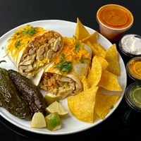 large Mission-style burrito w/green chicken + red sauce on the side + fried jalapeños (plated at home) at El Chupacabra - West in Seattle