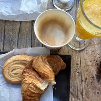 Had already eaten half of one of the pastries 😅 Two pastries, two glasses of fresh orange juice and a coffee with oat milk for 15€ - great price    at Caffe Trastevere in Rome