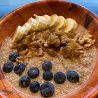 Bear Hug bowl (vegan) with quinoa, almond milk, almond butter, vanilla extract, cinnamon, golden raisins, walnuts, berries, bananas, agave.  at La Osita PDX in Portland