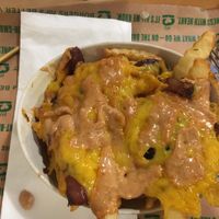 Special fries - cheese, “special sauce” and grilled red onions. - they were sweet like shallots at Next Level Burger in Bend