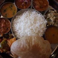 Rice with 8 different vegan curries and puri at Tharavadu in Leeds