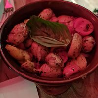 Baked potatoes with cherry tomatoes and onion at Spaghetti Pomodoro in Ticino