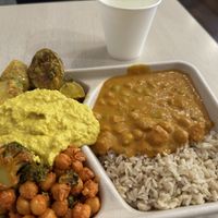 Hot Indonesian chickpea and rice, plus 2 side salads and hummus. only $20.50 NZD (£8.87 GBP) plus free water. Delicious food and super service. no plastic.   at Revive Cafe - Wyndham St in Auckland