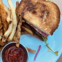 Roasted Delicata Sandwich with “Tofu Mozzarella, Pickled Red Onion, Mojo Verde Aioli, Dressed Arugula, Sourdough"  at Dreamstate Cafe in Minneapolis