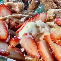 Closeup of the waffle smothered in vegan butter & sliced strawberries    at Katelyn’s Vegan Soul Cafe (2nd location) in Daytona Beach