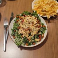 Kale Caesar. Kale, cashew parmesan, sundriwd tomato, roasted garlic, fried chickpeas, walnut caesar dressing at Avo in Nashville
