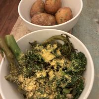 Smashed potatoes and garlic greens  at Plantuguese in England