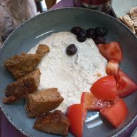 "Queso" de semillas de girasol, tomate y su seitan casero con olivas at Vegan Community Kitchen in Istanbul