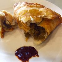 Sambusa, a triangle puff pastry filled with green lentils  at Rahel's Vegan Cuisine in Los Angeles