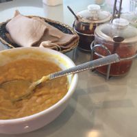 Yellow lentils, basket of spongy injera, and sauces at Rahel's Vegan Cuisine in Los Angeles