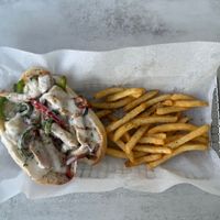 Chick’n Philly - hoagie roll loaded with savory, marinated plant-based chick'n. Topped with vegan provolone cheese and mixed with tender caramelized onions & bell peppers at Aisha's Plant-Based Eatery in Miami