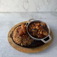 Vegan Oxtail with rice and peas: Tender plant-based chef made vegan oxtail slow-simmered in rich, savory caribbean-style gravy, served with rice & peas or jasmine rice.  at Aisha's Plant-Based Eatery in Miami