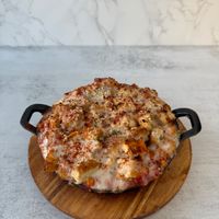 Chick’n Parm Mac & cheese: Creamy, dairy free mac & cheese topped with crispy, plant based parmesan chik'n, savory marinara sauce, melty mozzarella, topped with crispy breadcrumb at Aisha's Plant-Based Eatery in Miami