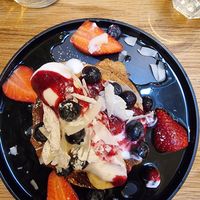 Pancake with coconut yoghurt, berries, banana and compote at Kin Cafe Vegetarian in London
