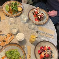 Kin hash (top left), waffles, pancakes, and avocado toast. at Kin Cafe Vegetarian in London