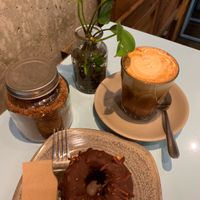 Almond latte with cinnamon and raw vegan gf donut.  at Raw Trader in Melbourne