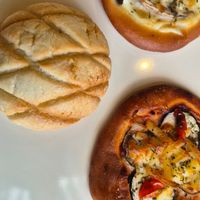 Melon bun, classic pizza bun, mushroom pizza bun at MERCY Vegan Bakery in Kyoto