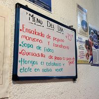 Menu of the day is written inside on this board, and also on a sandwich board in front of the unmarked restaurant door. at Comida Vegetariana in Mexico City