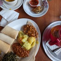 Vegetarian sampler with greens, lentils, cabbage and chickpeas plus Ethiopian spice tea and soup at Blue Nile Cafe in Kansas City