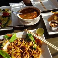 Green curry, hot and sour soup, golden triangles, vegetable noodle dish at My Thai Vegan Cafe in Boston
