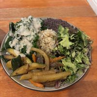 Collard greens with gravy, herbaceous salad, flavorful black beans, sautéed vegetables, and perfect brown rice.  at Himalaya Vegan Organic Restaurant in New York City