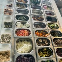 A wide variety of vegetables, seeds, and nuts to customize and add to your salad or rice bowl.  at Vegeta  in Tunis