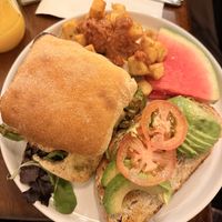 Vegan Sandwich with Roasted Potatoes and an Avocado Toast. Drink: freshly squeezed orange juice (delicious!)  at Brunch Vancouver in Vancouver