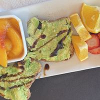 Avocado 🥑 toast with balsamic and a side of fruit  at The Mansion on 17th in Galveston
