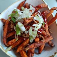 Sweet potato fries with spicy sauce and crispy onions at Garden Kitchen in London