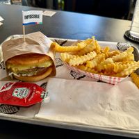 Vegan Impossible Burger (with vegan bun & vegan cheese) served with ketchup and fries at Grindhouse Killer Burgers in Brookhaven