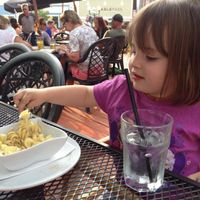 my daughter enjoying some pasta on the patio at Village Idiot in Revelstoke
