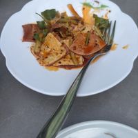 Man and wife slices in spicy saucee  at Tofu Vegan in Brighton
