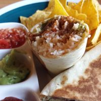 The Vegan Eagle's basic guacamole burrito with a wheat tortilla filled with 5 bean chili, spicy guacamole, salsa, iceberg lettuce salad, corn chips and rice. at The Vegan Eagle in Hamburg