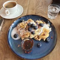 Vegan waffles with plant-based yogurt, maple syrup, blueberries and banana chips.  at Café Tacuba  in Luzern