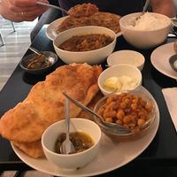 Chole bathura, mixed veg curry and side dish of parantha  at Nirvana Cafe in Luxembourg City