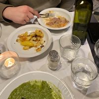 I have a blue cheese greens risotto, my partner has a ravioli and we had mini roast potatoes to share.   at La Colubrina in Milan