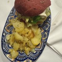 ‘White purple’ - beetroot bun, cauliflower, white cabbage, cannellini bean burger, mayo with mustard, roasted potatoes.  at La Colubrina in Milan