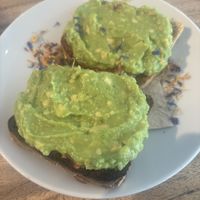 Smached avocado with tomatoes underneath.   at Wild Beets in Ibiza