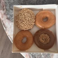 Plain, Apple custard crumble, and Biscoff crème  at Krispy Kreme in Brisbane