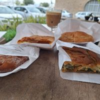 Spinach pie, bagel with olives, kind of a dough, sweet pastry with vegan "milk" at Aroma Cafe in Nafplio