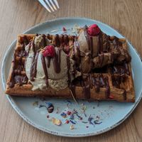 Waffle with chocolate sauce, pistachio and coffee ice cream at iceDate - Amalienstt in Munich