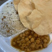 Coconut rice came with a surprise! Served with a small side of Chicpeas. I definitely recommend getting a more soupy dish like Aloo Chloe to go with this as it’s a lot of rice.  at Taj Chaat House in Irving